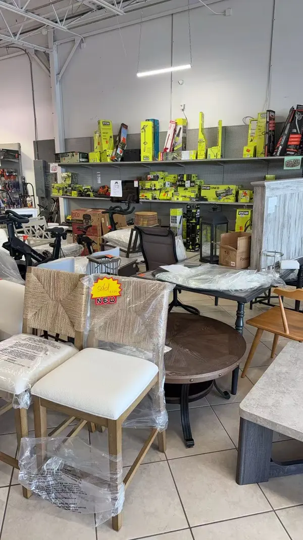 Discount furniture section featuring chairs and tables at 50% off retail prices